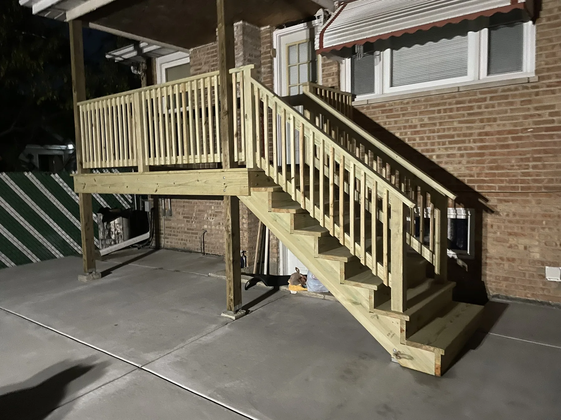 New pressure-treated wood deck stairs and railings