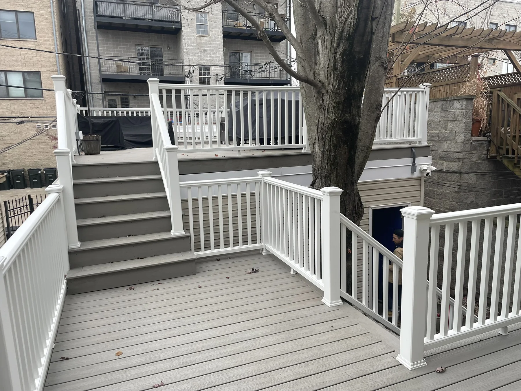 Finished outdoor deck and stair system with white railings