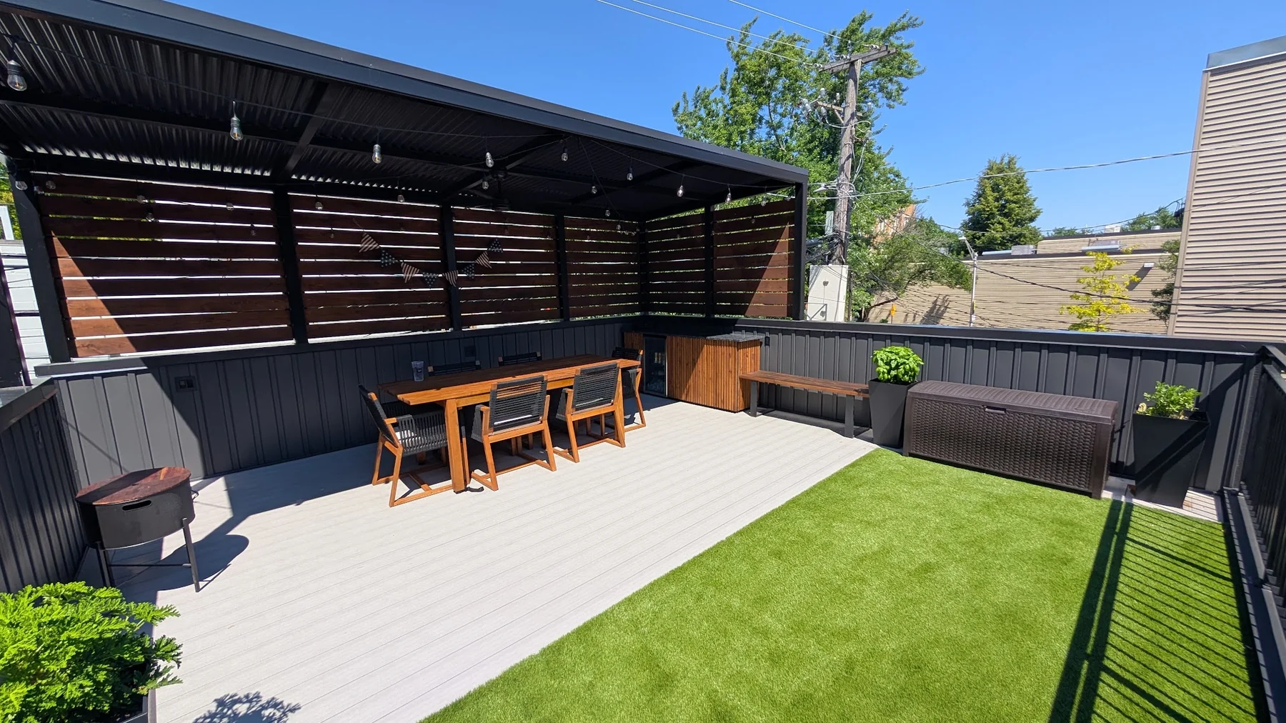 Chicago roof deck with covered dining area and wood privacy screen